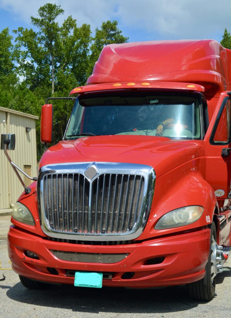 A red truck parked in front of a building.